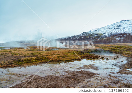 Geothermal steam from hot spring with snow mountain on wilderness 137166392
