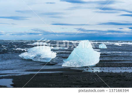 Seascape wave splashing on black sand beach and icebergs in Iceland Seascape wave splashing on black sand beach and icebergs in Iceland 137166394