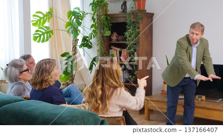 Friends playing movies game, gesturing and having fun at home Friends playing movies game, gesturing and having fun at home 137166407