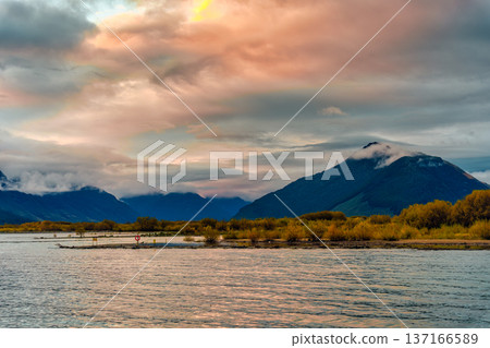 Lake Wakatipu with mountain range and autumn wilderness in the evening at New Zealand Lake Wakatipu with mountain range and autumn wilderness in the evening at New Zealand 137166589