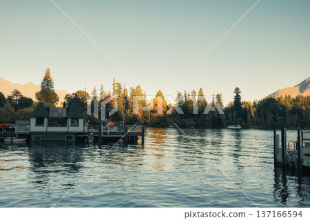 Scenic waterfront view of Queenstown pier and autumn trees on Lake Wakatipu, New Zealand Scenic waterfront view of Queenstown pier and autumn trees on Lake Wakatipu, New Zealand 137166594