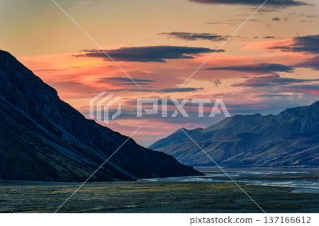 Sunset sky over Tasman valley with rugged mountain and field in autumn at New Zealand Sunset sky over Tasman valley with rugged mountain and field in autumn at New Zealand 137166612