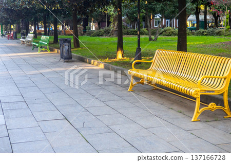 Colored benches in the park. Park infrastructure. Greenery in December. 137166728