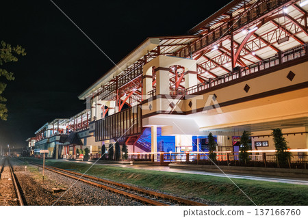 Illuminated large building of train station with railway platform in the night 137166760