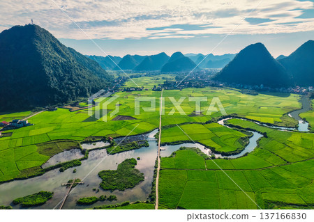 Beautiful Bac Son Valley with lush rice field, mountain range, winding river and rural village at Vietnam Beautiful Bac Son Valley with lush rice field, mountain range, winding river and rural village at Vietnam 137166830