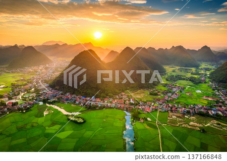 Beautiful sunset over Bac Son Valley with mountain, Lush rice fields and traditional village in countryside at Vietnam Beautiful sunset over Bac Son Valley with mountain, Lush rice fields and traditional village in countryside at Vietnam 137166848