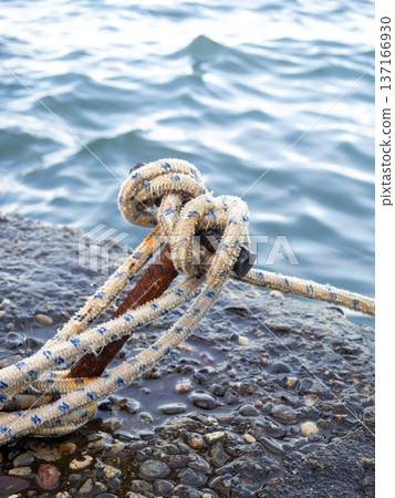 Place for attaching a small boat. Fittings for tying the mooring line. Mounting point. Small bollard on the pier. 137166930