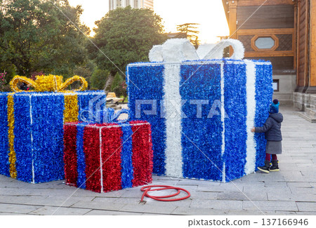 Concept of approaching holiday. Large decorative gift boxes on the street. Holiday packaging. Concept of approaching holiday. Large decorative gift boxes on the street. Holiday packaging. 137166946