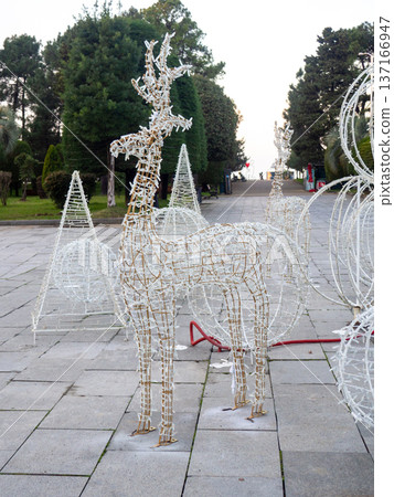 Installing New Year's decorations on the street. Festive figures for Christmas. Installing New Year's decorations on the street. Festive figures for Christmas. 137166947