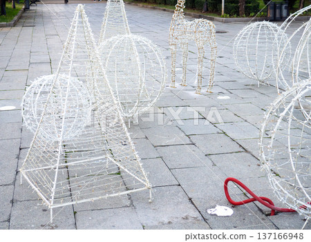 Installing New Year's decorations on the street. Festive figures for Christmas. Installing New Year's decorations on the street. Festive figures for Christmas. 137166948