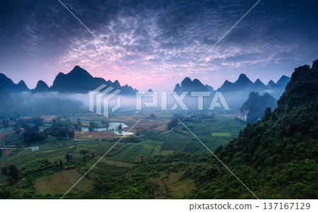 Dramatic sunrise over mountain range with foggy and river flows through in Phong Nam Valley Dramatic sunrise over mountain range with foggy and river flows through in Phong Nam Valley 137167129