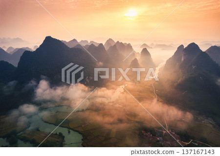 Golden sunrise over mountain range with foggy on rural village and river flows through in Phong Nam Valley at Cao Bang, Vietnam Golden sunrise over mountain range with foggy on rural village and river flows through in Phong Nam Valley at Cao Bang, Vietnam 137167143