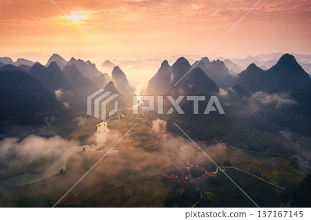 Golden sunrise over mountain range with foggy on rural village and river flows through in Phong Nam Valley at Cao Bang, Vietnam 137167145