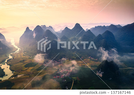 Beautiful sunrise over mountain range with foggy on rural village in Phong Nam Valley at Cao Bang, Vietnam Beautiful sunrise over mountain range with foggy on rural village in Phong Nam Valley at Cao Bang, Vietnam 137167146
