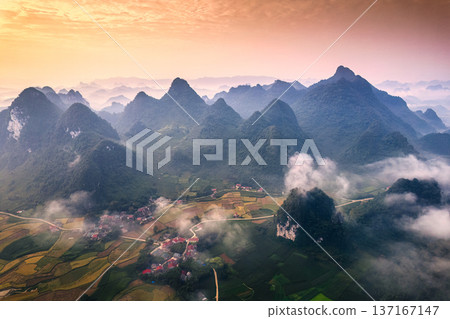 Beautiful sunrise over mountain range with foggy on rural village in Phong Nam Valley at Cao Bang, Vietnam Beautiful sunrise over mountain range with foggy on rural village in Phong Nam Valley at Cao Bang, Vietnam 137167147