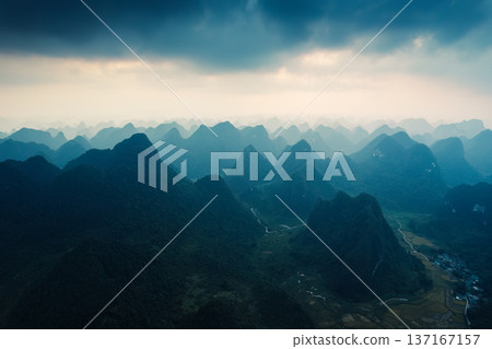 Sunlight shining over stacked mountain range on remote wilderness in countryside at Vietnam Sunlight shining over stacked mountain range on remote wilderness in countryside at Vietnam 137167157