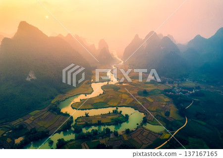 Golden sunrise over mountain range with winding river on agricultural village at Phong Nam Valley at Vietnam Golden sunrise over mountain range with winding river on agricultural village at Phong Nam Valley at Vietnam 137167165