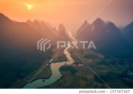 Golden sunrise over mountain range with winding river on agricultural village at Phong Nam Valley at Vietnam Golden sunrise over mountain range with winding river on agricultural village at Phong Nam Valley at Vietnam 137167167
