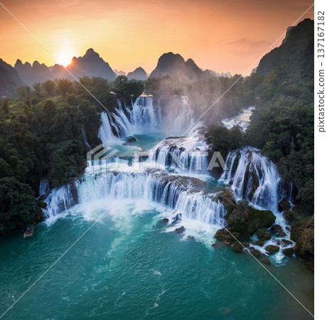 Majestic Ban Gioc waterfall, Detian Falls flowing in tropical forest during the sunset at Cao Bang, Vietnam 137167182