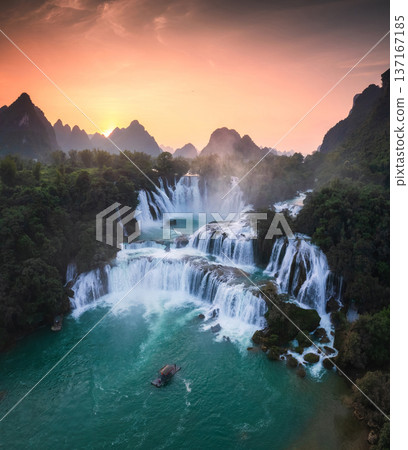 Majestic Ban Gioc waterfall, Detian Falls flowing in tropical forest during the sunset at Cao Bang, Vietnam 137167185