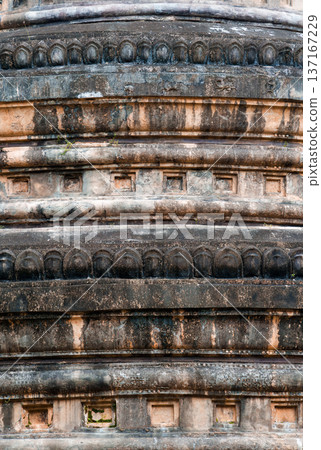 Aged ancient carved stone texture of stupa base Aged ancient carved stone texture of stupa base 137167229