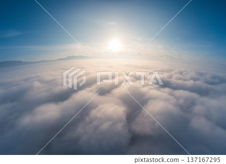 Sunrise over fluffy cloudy with foggy and blue sky Sunrise over fluffy cloudy with foggy and blue sky 137167295