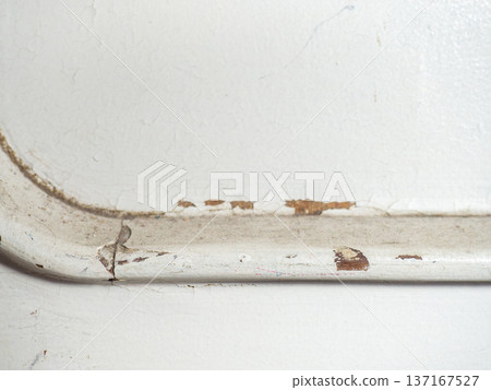 Part of an old door. White paint is coming off the wood. Surface with peeling paint. Part of an old door. White paint is coming off the wood. Surface with peeling paint. 137167527
