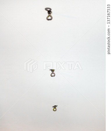 hammock hooks on a white ceiling. Metal mount on the ceiling. Reliable fastening. 137167533