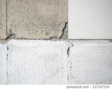background of broken white tiles. The wall needs repairs. The concept of ruin and abandonment. Chipped tile 137167559