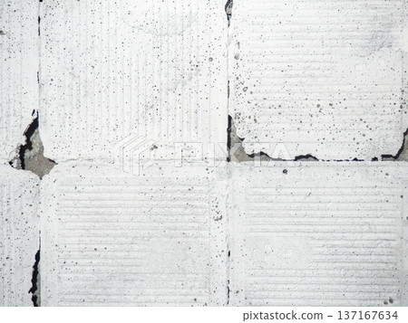 background of broken white tiles. The wall needs repairs. The concept of ruin and abandonment. Chipped tile. 137167634