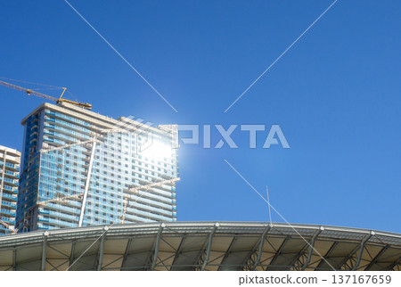 vault of a modern football stadium. Canopy of the sports arena. Metal construction. Stadium concept. Construction site nearby. 137167659