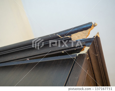 corner of the cabinet is broken. Crack in a wooden cabinet. Breakage when carrying furniture. Needs restoration. corner of the cabinet is broken. Crack in a wooden cabinet. Breakage when carrying furniture. Needs restoration. 137167731