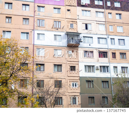 Old nine-story building. High-rise building in Asia. This is how the locals live. Unrenovated, scary, old building facade. Old nine-story building. High-rise building in Asia. This is how the locals live. Unrenovated, scary, old building facade. 137167745