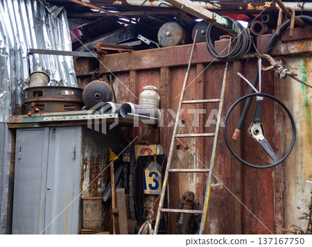 In an old auto repair shop. Rusty spare parts and machine elements. Abandoned car mechanic's office. Corrosion on spare parts. In an old auto repair shop. Rusty spare parts and machine elements. Abandoned car mechanic's office. Corrosion on spare parts. 137167750