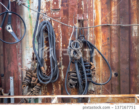 In an old auto repair shop. Rusty spare parts and machine elements. Abandoned car mechanic's office. Corrosion on spare parts. 137167751