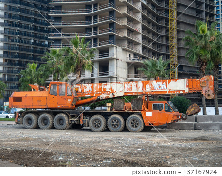 Crane on large wheels. Construction equipment. Non-working hours. Crane on large wheels. Construction equipment. Non-working hours. 137167924