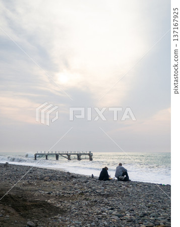 Destroyed pier under the waves. Bad weather at sea. Beautiful seashore with old architecture. Destroyed pier under the waves. Bad weather at sea. Beautiful seashore with old architecture. 137167925