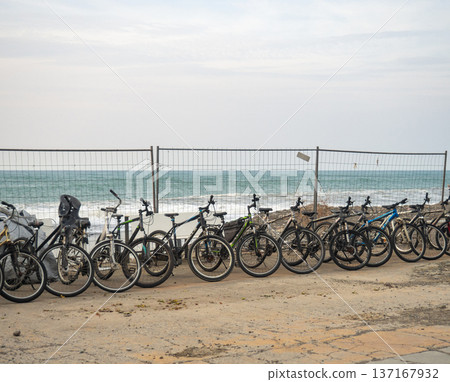 Bicycles for rent are located along the sea. Transport rental at the resort. Business on the beach. not a season . Bicycles for rent are located along the sea. Transport rental at the resort. Business on the beach. not a season . 137167932