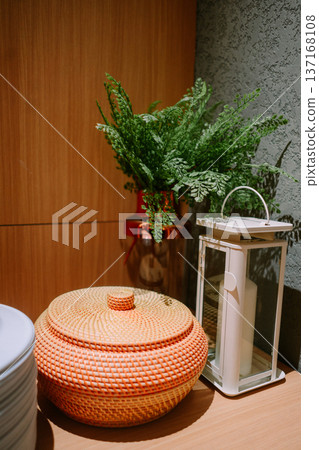 Cozy Home Decor Arrangement with Woven Basket and Greenery Cozy Home Decor Arrangement with Woven Basket and Greenery 137168108