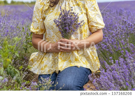 close-up hands of a woman holding purple lavender flowers bouquet. close-up hands of a woman holding purple lavender flowers bouquet. 137168208