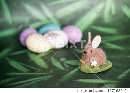 Cute easter bunny and colored eggs, green background 137168341