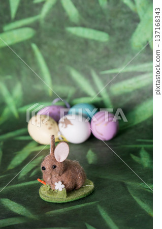 Cute easter bunny and colored eggs, green background Cute easter bunny and colored eggs, green background 137168343