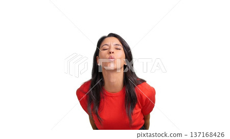 Woman blowing kiss with eyes closed in studio 137168426