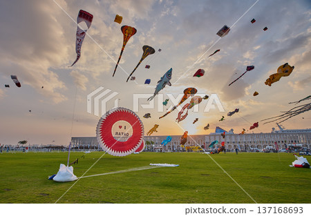 Doha, Qatar - January 20 2026: Qatar Kite Festival 2026 in Old Doha port (Mina District) sunset shot showing spectacular showcase of colorful kites soaring across the picturesque Doha skyline. Doha, Qatar - January 20 2026: Qatar Kite Festival 2026 in Old Doha port (Mina District) sunset shot showing spectacular showcase of colorful kites soaring across the picturesque Doha skyline. 137168693