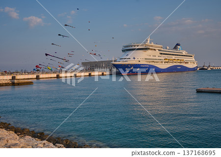 Doha, Qatar - January 20 2026: Qatar Kite Festival 2026 in Old Doha port (Mina District) sunset shot showing spectacular showcase of colorful kites soaring across the picturesque Doha skyline. Doha, Qatar - January 20 2026: Qatar Kite Festival 2026 in Old Doha port (Mina District) sunset shot showing spectacular showcase of colorful kites soaring across the picturesque Doha skyline. 137168695