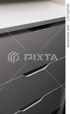 Modern shelving unit with a drawers in a wardrobe 137168700