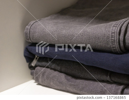 A stack of folded jeans and casual clothing 137168865