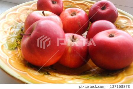 Apples on a yellow plate. Apples on a yellow plate. 137168878