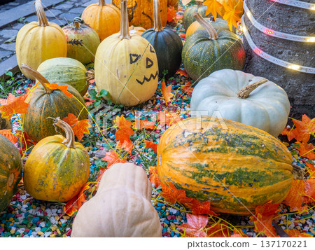 Decorations for Halloween on the street near the restaurant. Autumn holiday decorations. Illuminations. Restaurant patio decoration. Painted multi-colored pumpkins. All Saints' Day. The holiday is Decorations for Halloween on the street near the restaurant. Autumn holiday decorations. Illuminations. Restaurant patio decoration. Painted multi-colored pumpkins. All Saints' Day. The holiday is 137170221