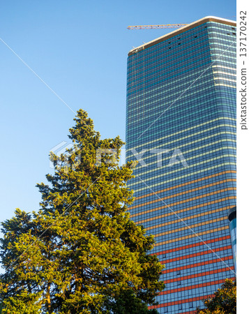 Modern construction of a high-rise building. Modern architecture of a business center. Apartment in a high-rise building. Modern construction of a high-rise building. Modern architecture of a business center. Apartment in a high-rise building. 137170242